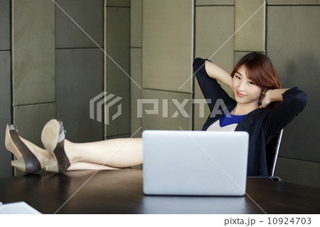 The young business woman is relaxing at work The young business woman is relaxing at work 10924703