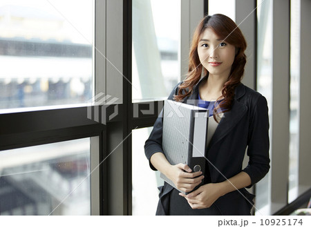 Young asian business woman holding file document Young asian business woman holding file document 10925174