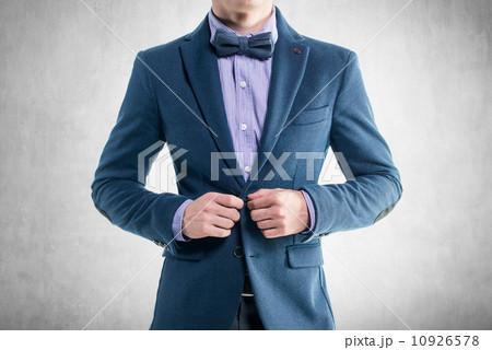 Handsome elegant young fashion man in coat tuxedo classical costume suit and bow tie 10926578