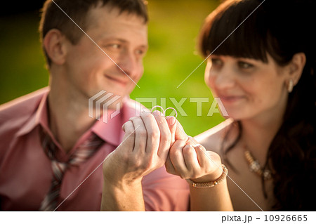 portrait with selective focus on wedding rings held by smiling c portrait with selective focus on wedding rings held by smiling c 10926665