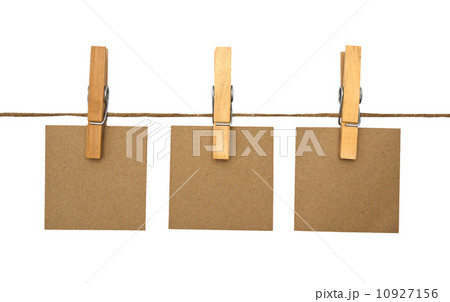 close up of a notes and a clothes pegs on white background 10927156