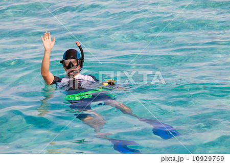 Man in flippers and mask in ocean, Maldives 10929769