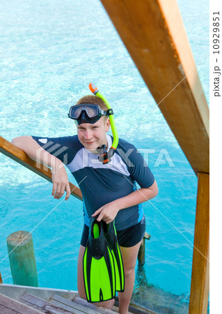 The boy with flippers, mask and tube for scuba diving. Maldives The boy with flippers, mask and tube for scuba diving. Maldives 10929851