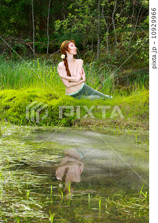 The girl-witch in dense wood on the bank of wood lake 10929966