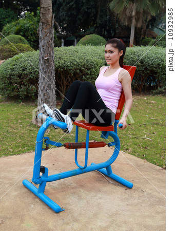 woman exercising with exercise equipment in the park 10932986