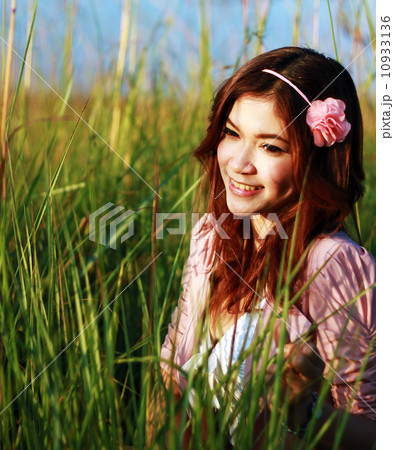Portrait of beautiful young Asian girl in the grass Portrait of beautiful young Asian girl in the grass 10933136