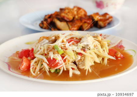 spicy papaya salad and roasting chicken 10934697
