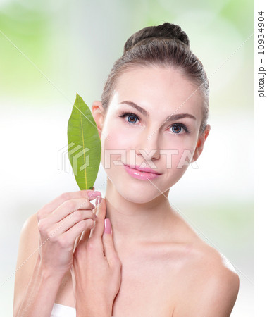 beautiful woman face portrait with green leaf 10934904