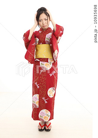 頭を抱える浴衣の女性 10935698