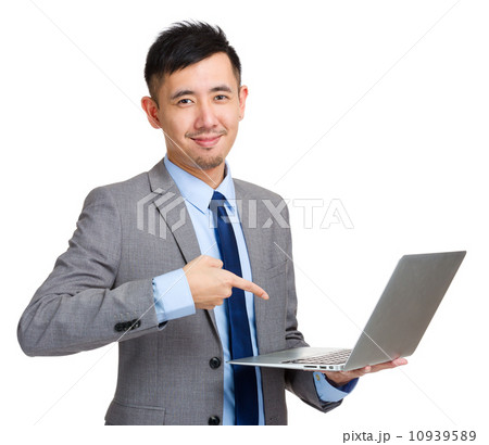 Businessman holding laptop and finger pointing to screen 10939589
