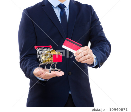 Businessman holding credit card and shopping cart with coin 10940671
