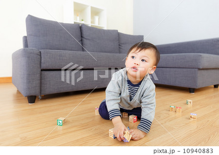 Asian baby boy play with toy block at home 10940883