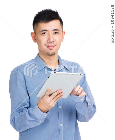 Young man touching on tablet Young man touching on tablet 10941128
