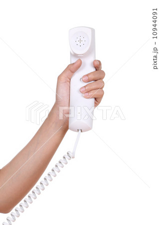 Hand holding white telephone tube Hand holding white telephone tube 10944091
