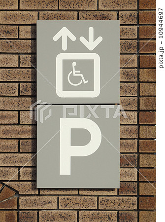 Disabled parking sign on brick wall 10944697