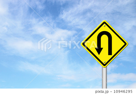 Yellow warning sign u-turn roadsign with blue sky background 10946295