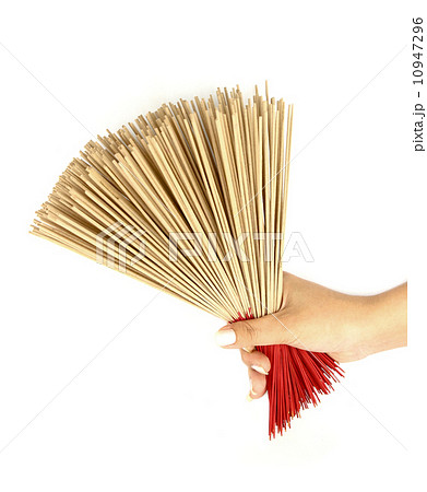 hand holding incense on white background hand holding incense on white background 10947296