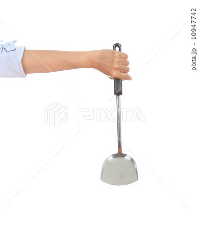 woman hand holding a kitchen spatula 10947742