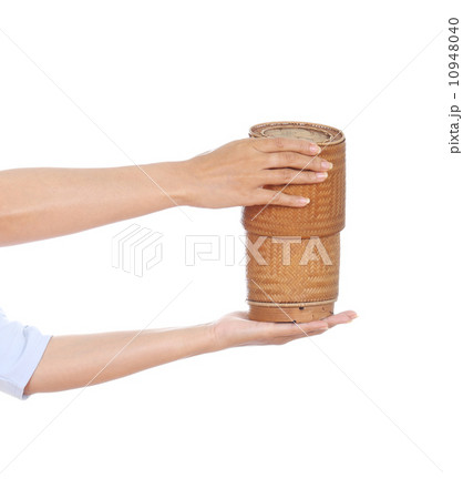 hand holding bamboo rice box 10948040