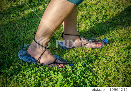 Woman feet wearing plastic bottle sandals 10964212