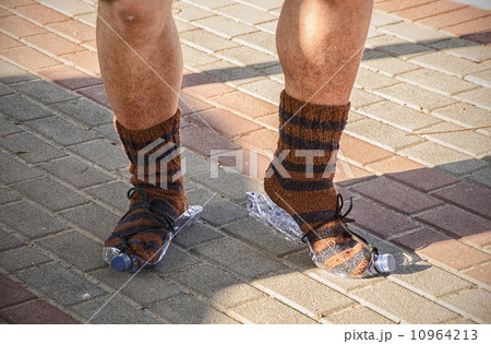 Dancing feet of the homeless in knitted socks 10964213