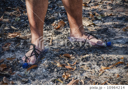 Hobo standing in bottle sandals on wood ashes 10964214