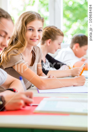 Students writing a test in school concentrating 10968484