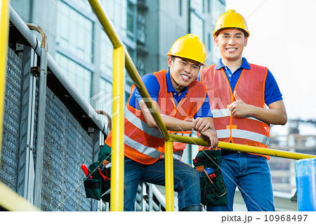 Asian Indonesian construction workers on building site 10968497