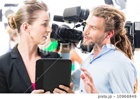 Director giving cameraman direction for video production Director giving cameraman direction for video production 10968849