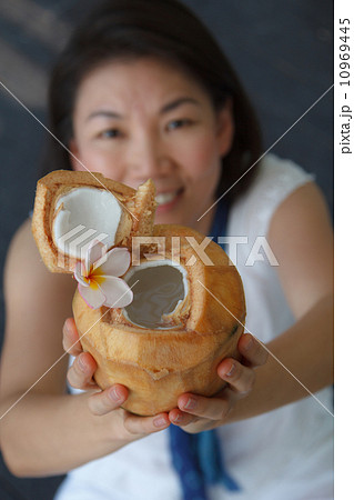 vivacious woman giving a coconut water vivacious woman giving a coconut water 10969445
