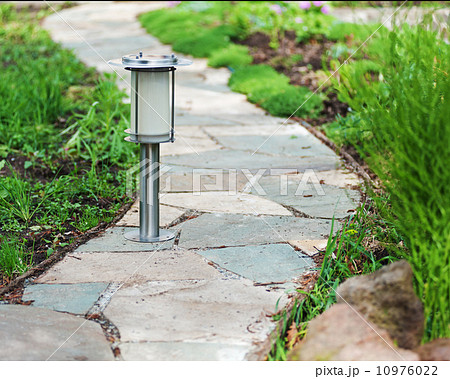 Solar-powered lamp on garden background. Solar-powered lamp on garden background. 10976022