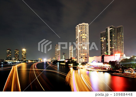 Boat light trails on Chao Phraya river Boat light trails on Chao Phraya river 10988448