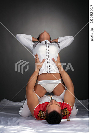 Sexy dancer posing sitting astride her partner 10992917