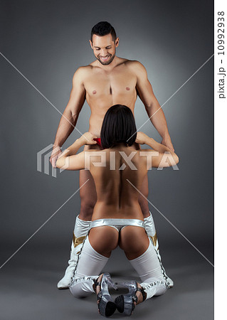 Cheerful man watching how girl takes off his pants 10992938