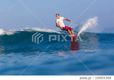 Surfing a wave. 10993368