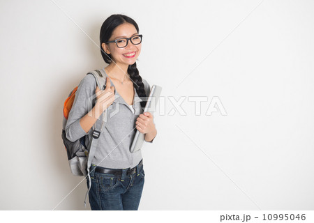 asian female college student with books and laptop 10995046