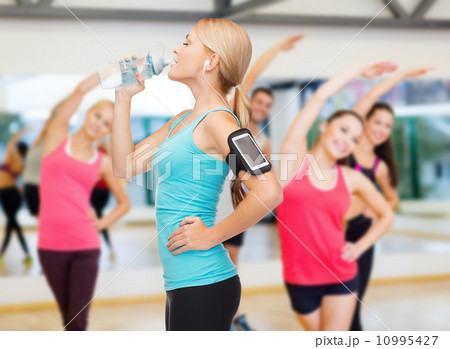sporty woman running with smartphone and earphones sporty woman running with smartphone and earphones 10995427