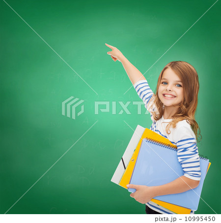 cute girl with folders pointing at virtual screen cute girl with folders pointing at virtual screen 10995450