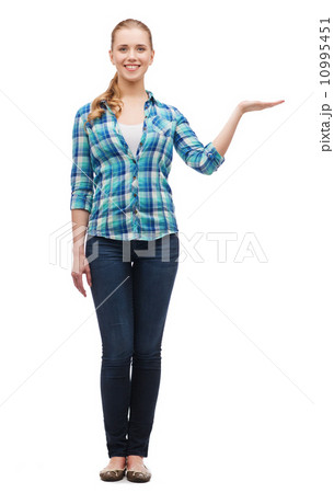 smiling young woman holding something on hand smiling young woman holding something on hand 10995451
