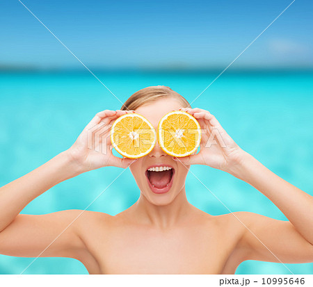 amazed young woman with orange slices 10995646