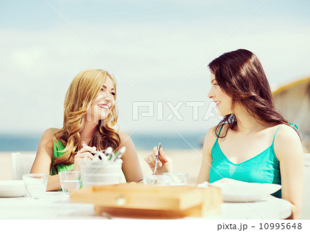 girls in cafe on the beach girls in cafe on the beach 10995648