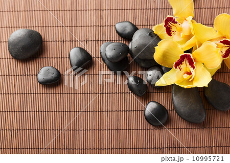 massage stones with flowers on mat 10995721