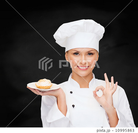 smiling female chef with cake on plate smiling female chef with cake on plate 10995863