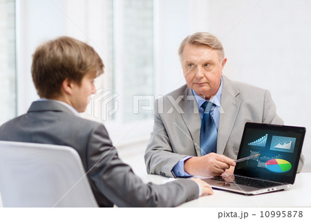older man and young man with laptop computer 10995878