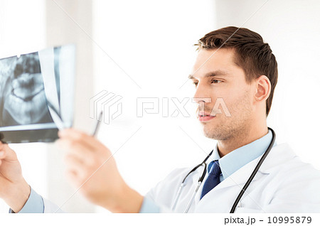 male doctor or dentist looking at x-ray male doctor or dentist looking at x-ray 10995879