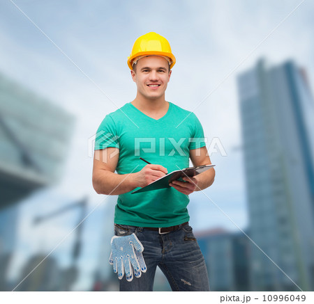 smiling man in helmet with clipboard 10996049
