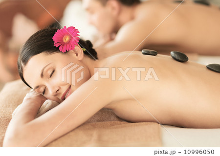 couple in spa with hot stones couple in spa with hot stones 10996050