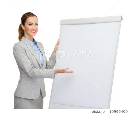smiling businesswoman standing next to flipboard smiling businesswoman standing next to flipboard 10996400