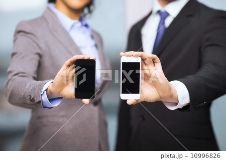 businessman and businesswoman with smartphones businessman and businesswoman with smartphones 10996826