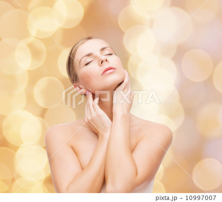 beautiful woman touching her face with closed eyes 10997007